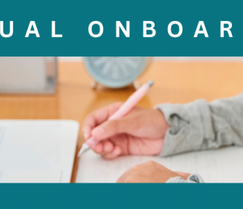 Student writing next to laptop